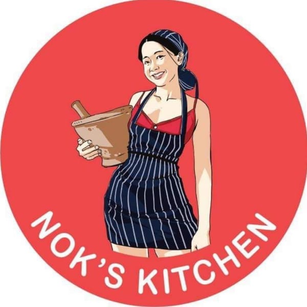 Cartoon of a smiling woman in an apron holding a mortar and pestle, with "Nok's Kitchen" text.